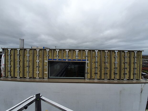 The ACM and insulation were replaced with bronze A1 anodised panels