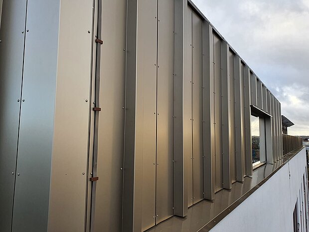 The ACM and insulation were replaced with bronze A1 anodised panels